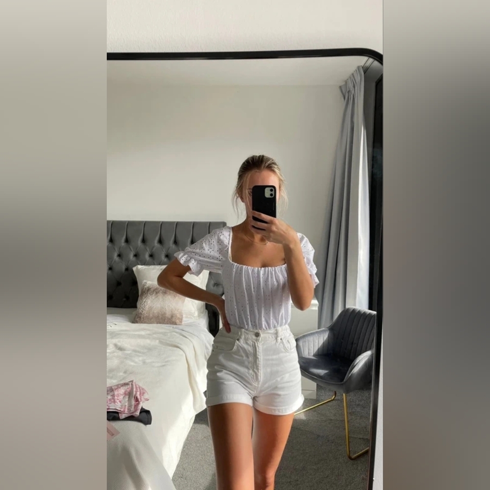 White Ruffled Blouse and High-Waisted Shorts